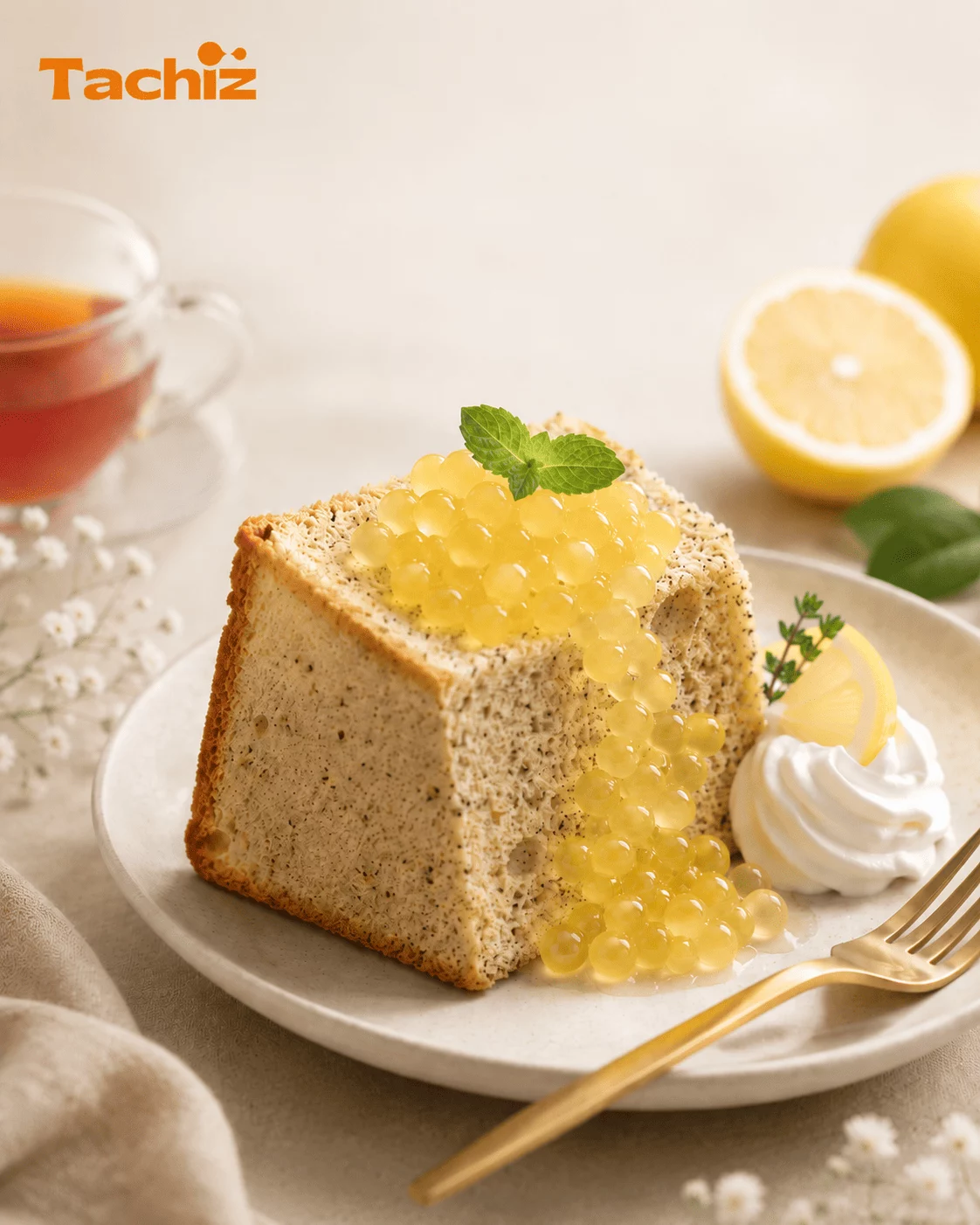A slice of black tea chiffon cake topped with bright yellow lemon popping boba